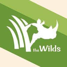 Graphic of 2 thick stripes in different shades of green with what looks like 4 white tusks sticking out of the dark green and what looks like a rhino head silhouette in white with the Wilds written underneath