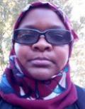 Zaina Hussein, a Black woman wearing a head scarf and sunglasses