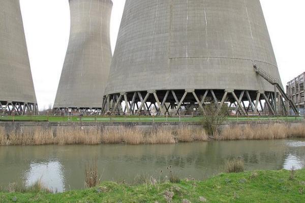 Power plant cooling towers beside a river