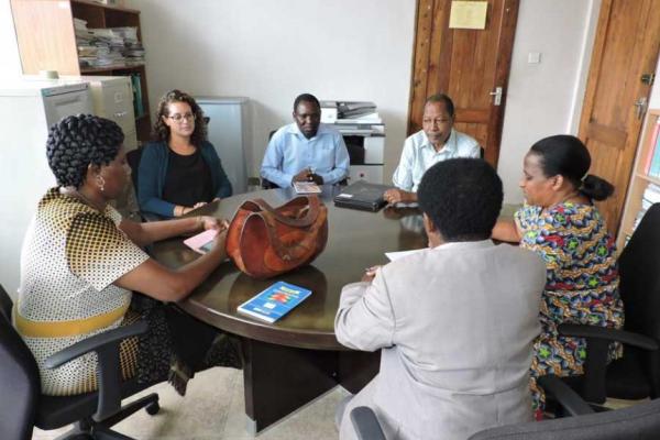 A mixed race of people in business wear sitting around a table