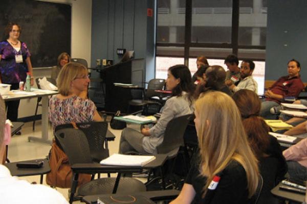 A mixed race, mixed gender group of adults in a college classroom