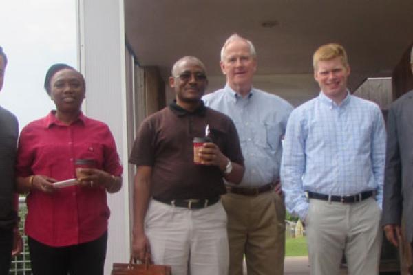 Mixed race, mixed gender group of people in business casual wear standing outside of a building