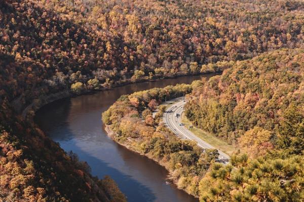 Landscape of rive going through tree covered hills, 