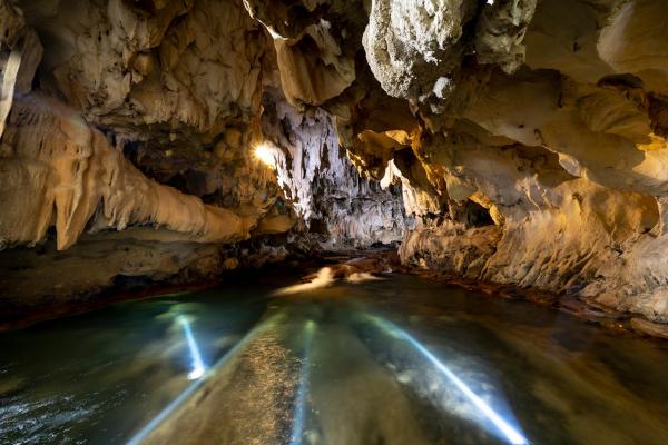 Underground rocky cave and body of water.