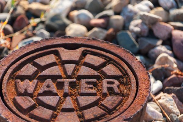 rusty water supply lid on ground.