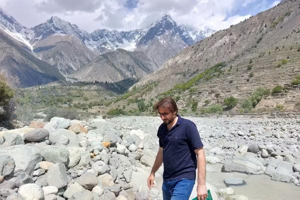 A man walking in a dry river bedrock